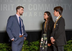 Olympic gold medalist Michael Phelps congratulates Meghana Reddy, 18, of La Mesa (center) and Kenan Pala, 13, of San Diego (right) on being named California's top two youth volunteers for 2017 by The Prudential Spirit of Community Awards. Meghana and Kenan were honored at a ceremony on Sunday, May 7 at the Smithsonian's National Museum of Natural History, where they each received a $1,000 award. (PRNewsfoto/Prudential Insurance)